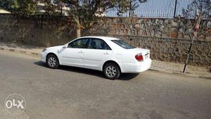 Toyota camry  white with insurance and well maintained